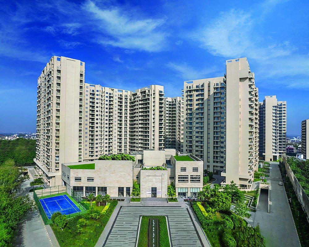 Aerial view of the central green, football field and courts at Ambience Creacions